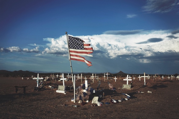  A shredded American flag at a grave site in Blackwater, Arizona. Photograph: Steve Craft for the Guardian